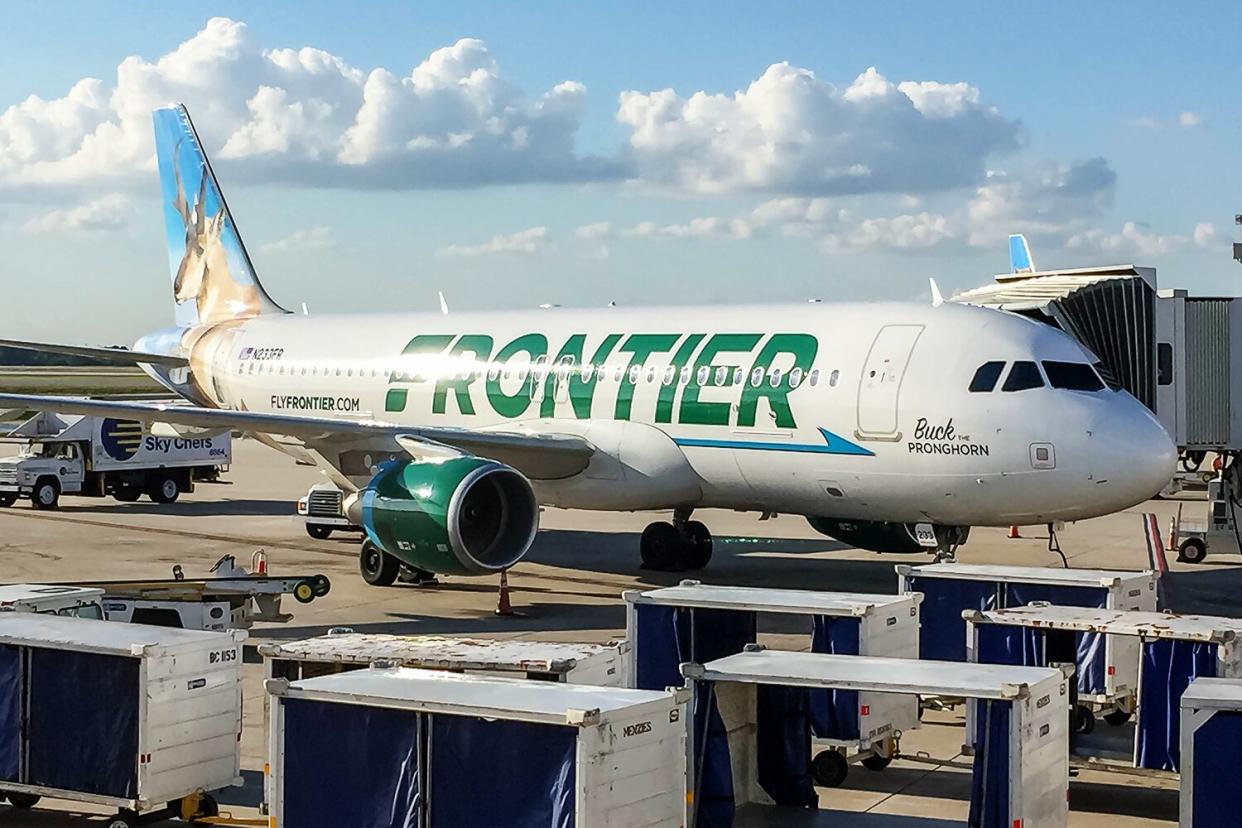 Orlando International Airport, Florida - November 1st, 2016 - Frontier Airlines, Airbus A320-214, N233FR "Buck the Pronghorn" parked at the departure gate.