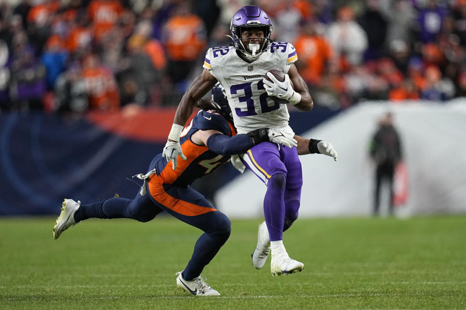 Minnesota Vikings running back Ty Chandler (32) is tackled by Denver Broncos linebacker Alex Singleton during the second half on an NFL football game, Sunday, Nov. 19, 2023, in Denver. (AP Photo/Jack Dempsey)