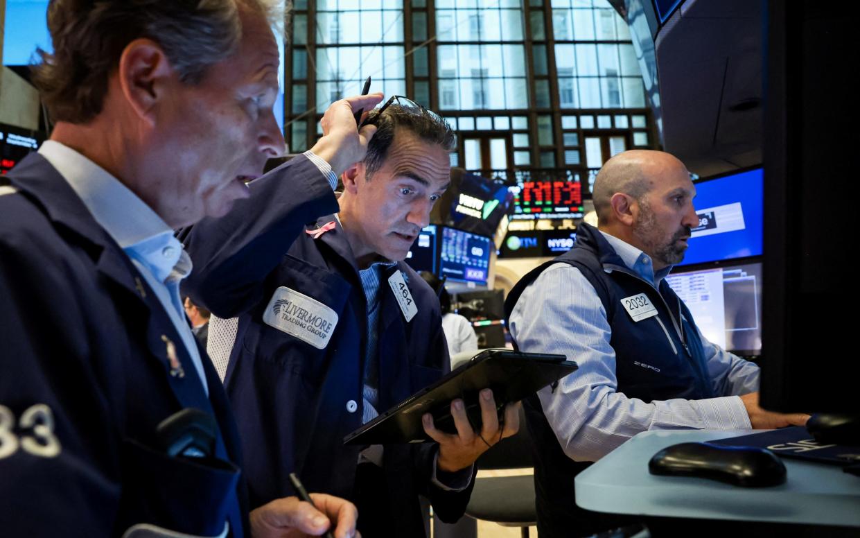 Traders work on the floor at the New York Stock Exchange today