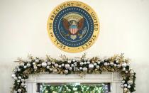 The Presidential Seal sits above festive gold and silver ornaments.