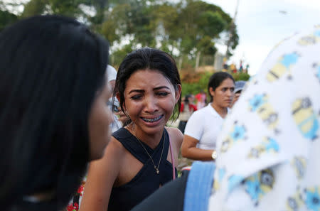 Relatives of inmates react in front of a prison complex in the Brazilian state of Amazonas after prisoners were found strangled to death in four separate jails, according to the penitentiary department in Manaus, Brazil May 27, 2019. REUTERS/Bruno Kelly