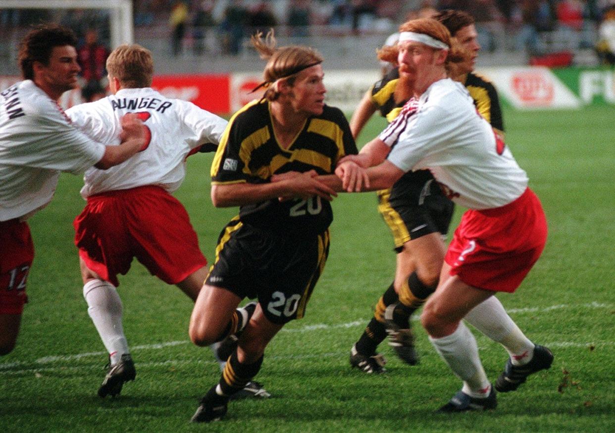 Crew #20 Brian McBride, who scored two goals, is checked by Alexi Lalas of New England Saturday, May 11, 1996 in Ohio Stadium. (Dispatch file photo)