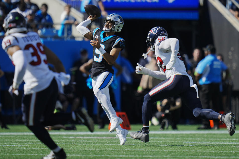 Carolina Panthers quarterback Bryce Young (9) passes under pressure by Houston Texans defensive end Jonathan Greenard (52) during the first half of an NFL football game, Sunday, Oct. 29, 2023, in Charlotte, N.C. (AP Photo/Rusty Jones)