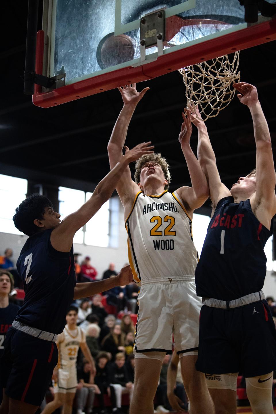 Archbishop Wood senior Carson Howard scores on a layup between CB East's Dhruv Mukund (2) and Jake Cummiskey during the Vikings' PIAA Class 6A first-round state playoff win.