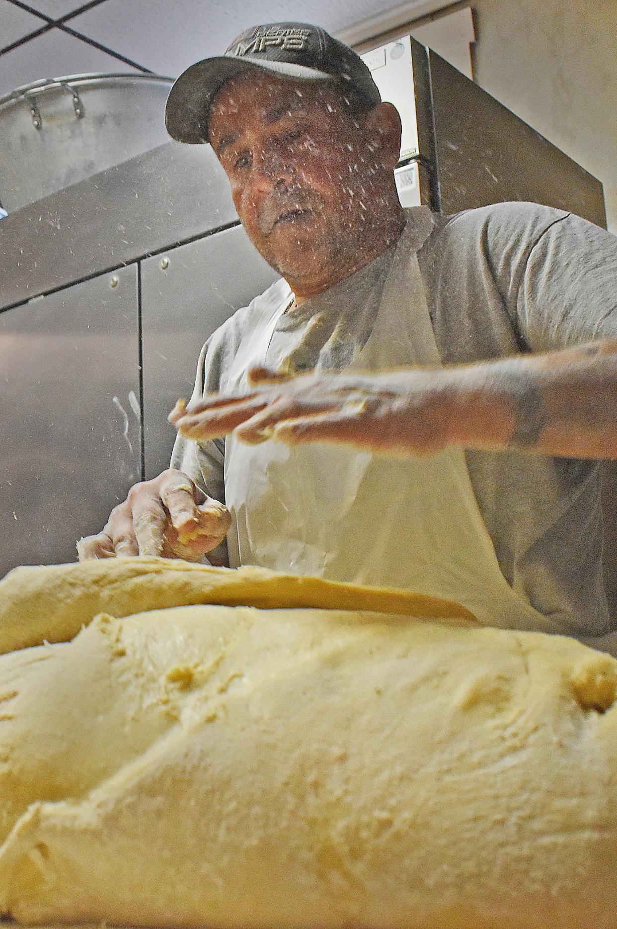 Owner John Arruda works with the sweet bread dough at Lou's Bakery on East Main Street in Fall River on Thursday, March 21, 2024.