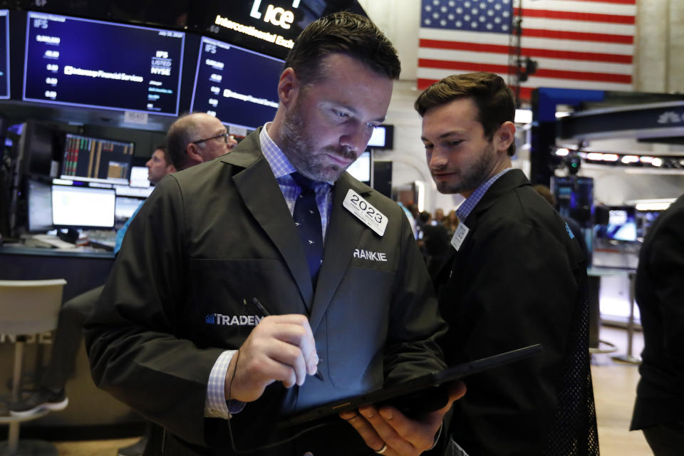 Traders Frank Masiello, left, and Joshua Trinker workon the floor of the New York Stock Exchange, Friday, July 19, 2019. U.S. stocks moved broadly higher in early trading on Wall Street Friday and chipped away at the week's losses. (AP Photo/Richard Drew)