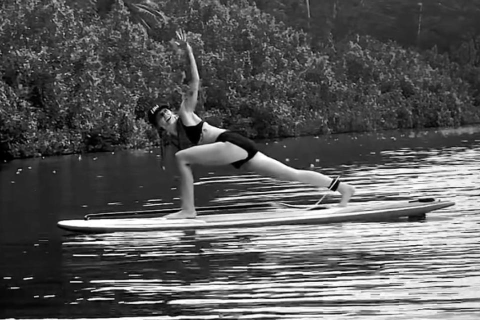 <p>Miley Cyrus/Instagram</p> Miley Cyrus pictured in her paddleboard yoga video on Oct 29