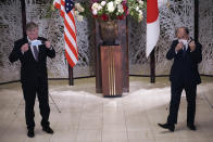 U.S. Special Representative for North Korea Stephen Biegun, left, and Japanese Vice Foreign Minister Takeo Akiba, right, take off their protective masks for a photo session prior to their bilateral meeting at Iikura Guest House Thursday, July 9, 2020, in Tokyo. (AP Photo/Eugene Hoshiko, Pool)