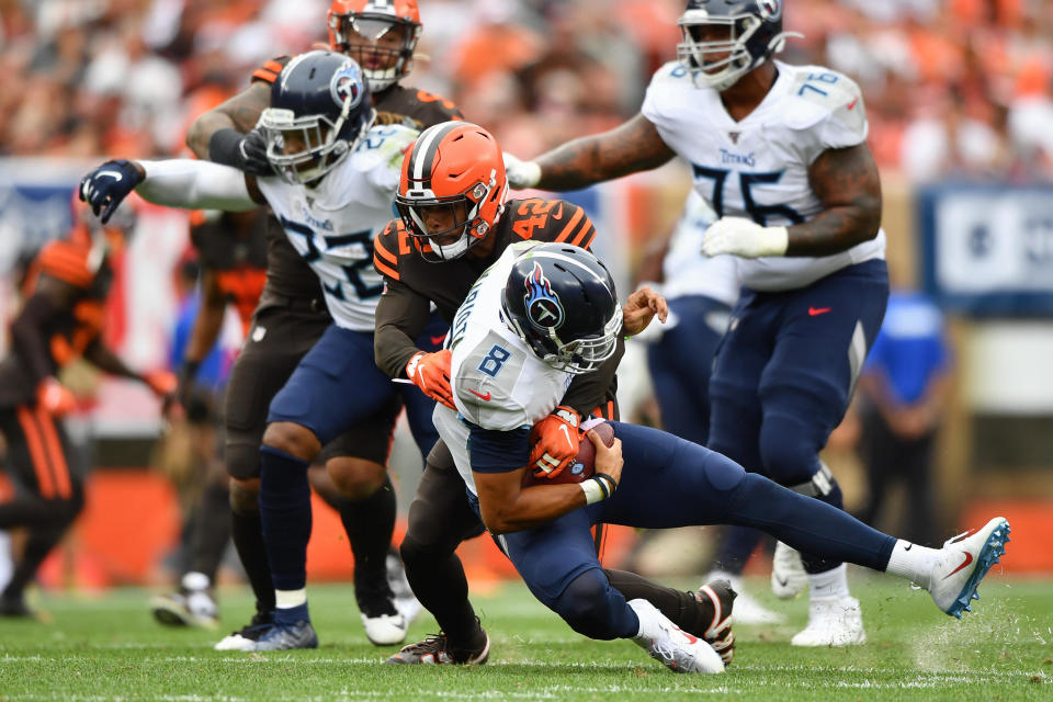 Marcus Mariota #8 of the Tennessee Titans is sacked by Morgan Burnett #42 of the Cleveland Browns in the second quarter at FirstEnergy Stadium on September 08, 2019 in Cleveland, Ohio . (Photo by Jamie Sabau/Getty Images)