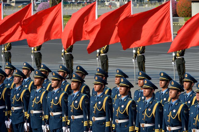 Members of the honour guard prepare for the arrival of Chinese President Xi Jinping, near the Great Hall of the People in Beijing, on June 19, 2013
