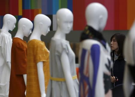 A woman looks at creations displayed on mannequins at Tokyo Fantashion 2015 at a shopping district in Tokyo, Japan, August 16, 2015. REUTERS/Yuya Shino/Files