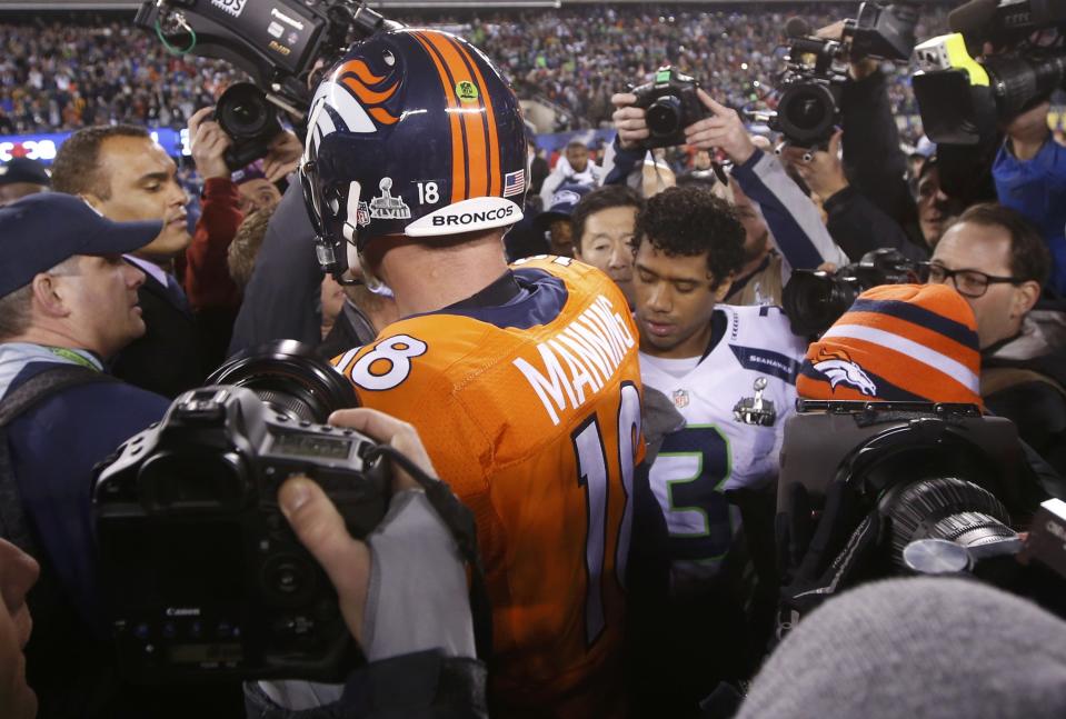 Denver Broncos quarterback Manning (L) shakes hands with Seattle Seahawks quarterback Russell Wilson after the Seahawks defeated the Broncos in the NFL Super Bowl XLVIII in East Rutherford, New Jersey