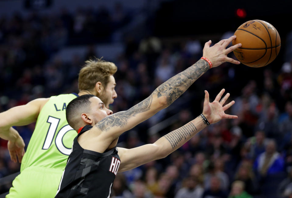Houston Rockets guard Austin Rivers and Minnesota Timberwolves forward Jake Layman (10) in the first quarter during an NBA basketball game Saturday, Nov. 16, 2019 in Minneapolis. (AP Photo/Andy Clayton- King)