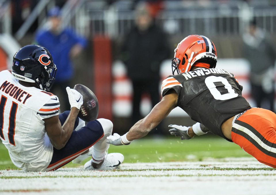 Chicago Bears' Darnell Mooney (11) can't hold onto a Hail Mary pass in front of Cleveland Browns' Greg Newsome II (0) at the end of an NFL football game, Sunday, Dec. 17, 2023, in Cleveland. (AP Photo/Sue Ogrocki)