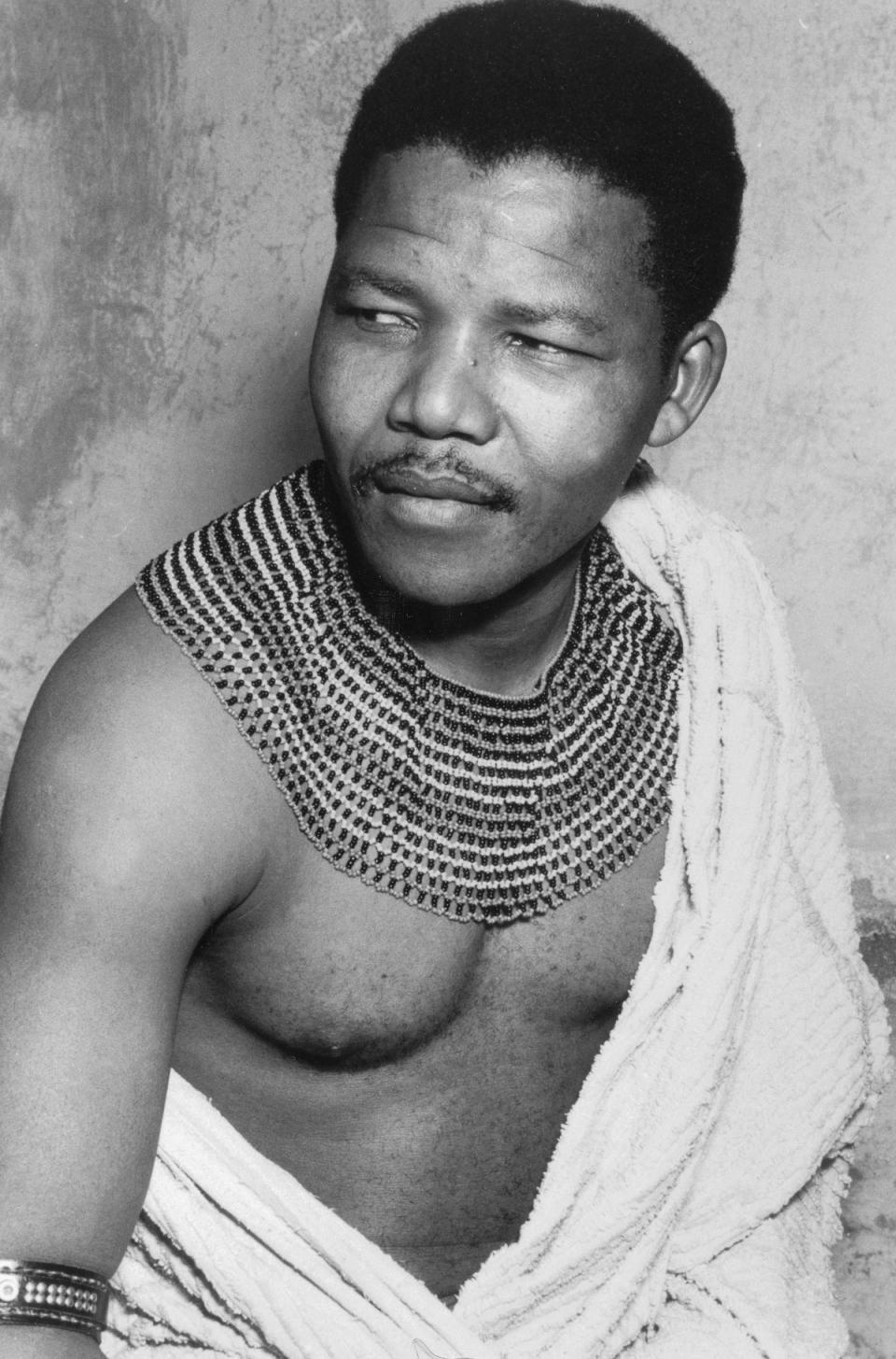Nelson Mandela wearing traditional beads and a bed spread during his time in hiding from the police, South Africa, 1961 (Getty Images)