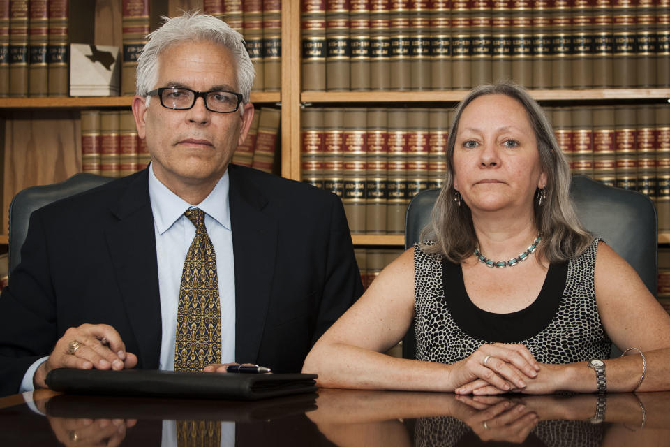 In this July 1, 2011, photo, Sandra Rawline, 52, right, poses with her lawyer Robert "Bigs" Dowdy at the Law Offices of Tom F. Coleman in Galveston, Texas. Rawline has filed an age discrimination and retaliation lawsuit against her former company, Capital Title of Texas, and alleges that she was told to wear younger outfits and dye her gray hair. (AP Photo/The Houston Chronicle, Patrick T. Fallon) MANDATORY CREDIT