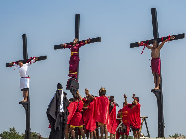 PAMPANGA, SAN FERNANDO, SAN PEDRO, LUZON, PHILIPPINES - 19/04/2019: Crucifixion in Philippines, people with nailed hands and feet to the cross, crowd, Good Friday during Easter, filipino catholics