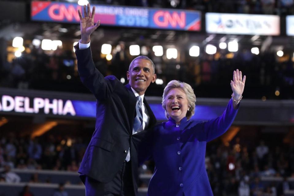 US President Barack Obama and Democratic Presidential nominee Hillary Clinton wave to the crowd on the third day of the Democratic National Convention at the Wells Fargo Center, July 27, 2016 in Philadelphia, Pennsylvania. (Photo by Chip Somodevilla/Getty Images)