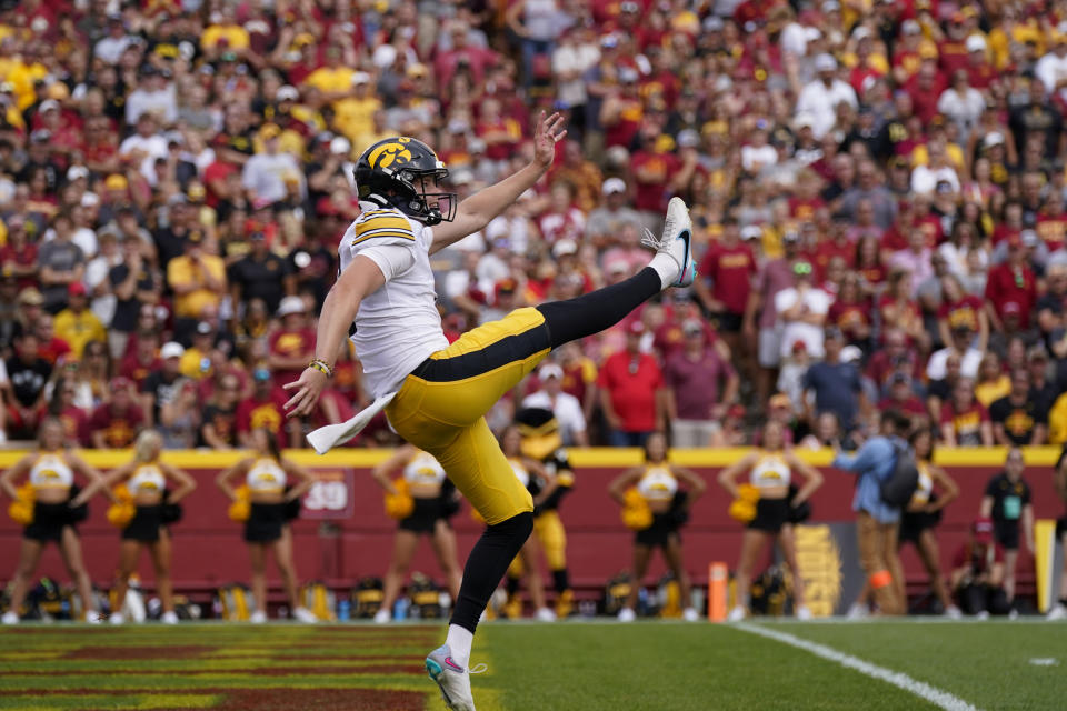 FILE - Iowa punter Tory Taylor (9) punts during the first half of an NCAA college football game against Iowa State, Saturday, Sept. 9, 2023, in Ames, Iowa. Taylor has been selected to The Associated Press midseason All-America team, Wednesday, Oct. 18, 2023.(AP Photo/Charlie Neibergall, File)