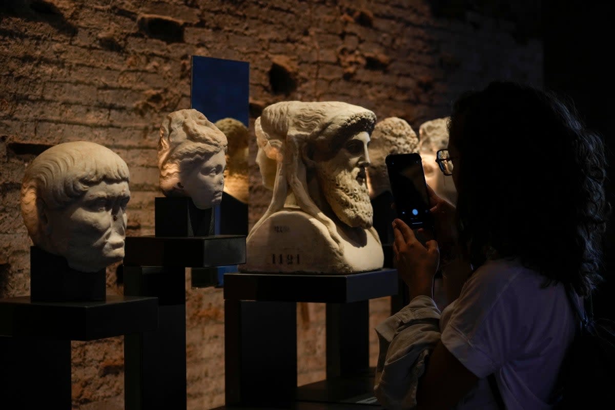 A visitor admires archeological finds inside the newly restored domus Tiberiana, one of the main imperial palaces, on Rome’s Palatine Hill (AP)