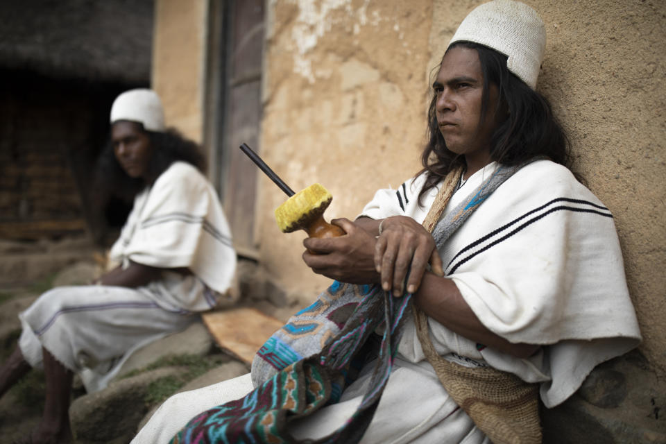 Arhuaco Indigenous men gather and chew coca leaves in Nabusimake on the Sierra Nevada de Santa Marta, Colombia, Tuesday, Jan. 17, 2023. For he Arhuaco people the coca plant, which they call Ayu, is sacred. (AP Photo/Ivan Valencia)