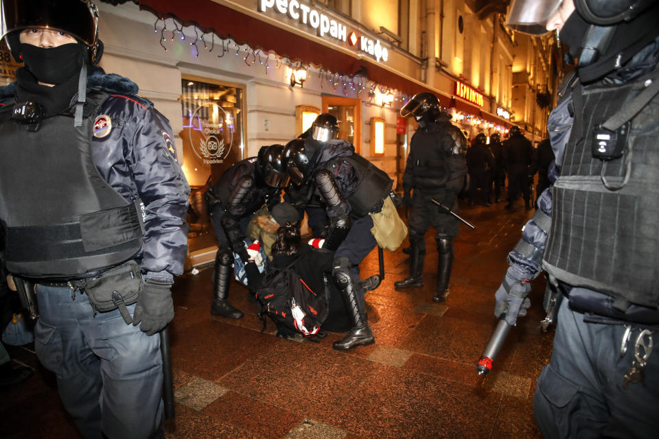 Police officers detain Navalny supporters during a protest in St. Petersburg, Russia, Tuesday, Feb. 2, 2021. A Moscow court has ordered Russian opposition leader Alexei Navalny to prison for more than 2 1/2 years on charges that he violated the terms of his probation while he was recuperating in Germany from nerve-agent poisoning. Navalny, who is the most prominent critic of President Vladimir Putin, had earlier denounced the proceedings as a vain attempt by the Kremlin to scare millions of Russians into submission. (AP Photo/Dmitri Lovetsky)