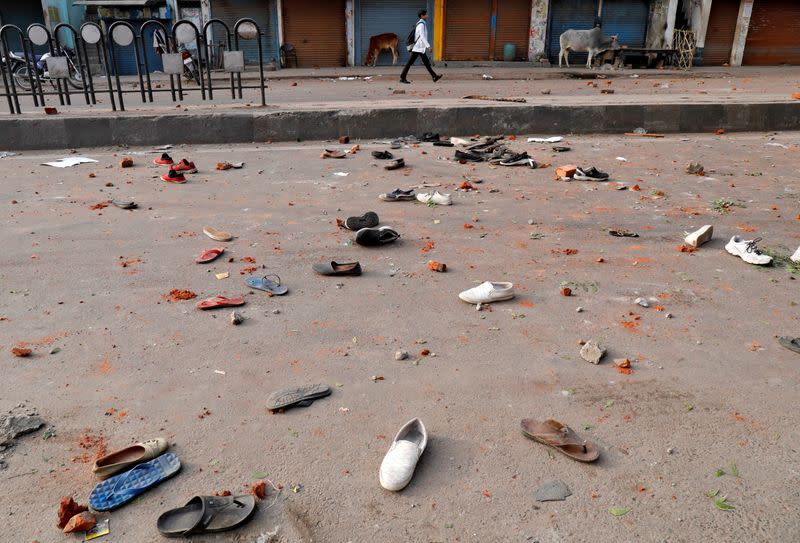 Shoes of demonstrators are seen scattered along a road after a protest against a new citizenship law, in Lucknow