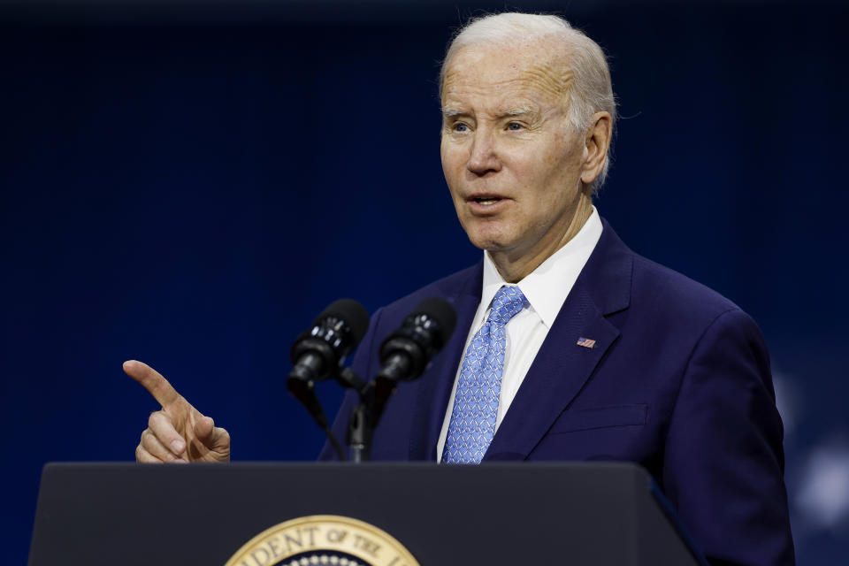 President Biden stands at a podium while giving a speech.