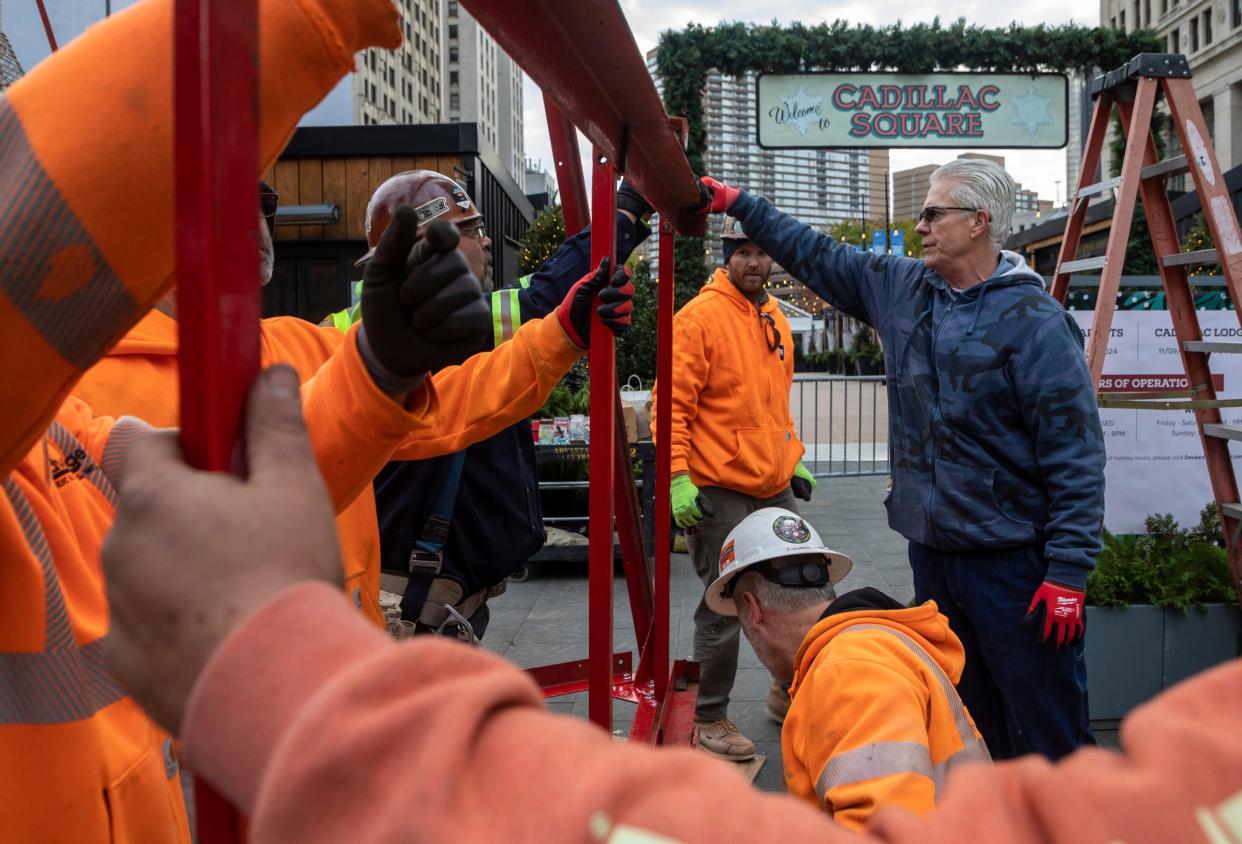 Kevin Andrews, 62, of Macomb Township, a maintenance supervisor for The Salvation Army Great Lakes Division, helps assemble a giant red kettle early in the morning with the help of Local 25 men of steel, Advantage Electric and Controls and Frank Rewold at Cadillac Square in Detroit on Friday, Nov. 10, 2023.