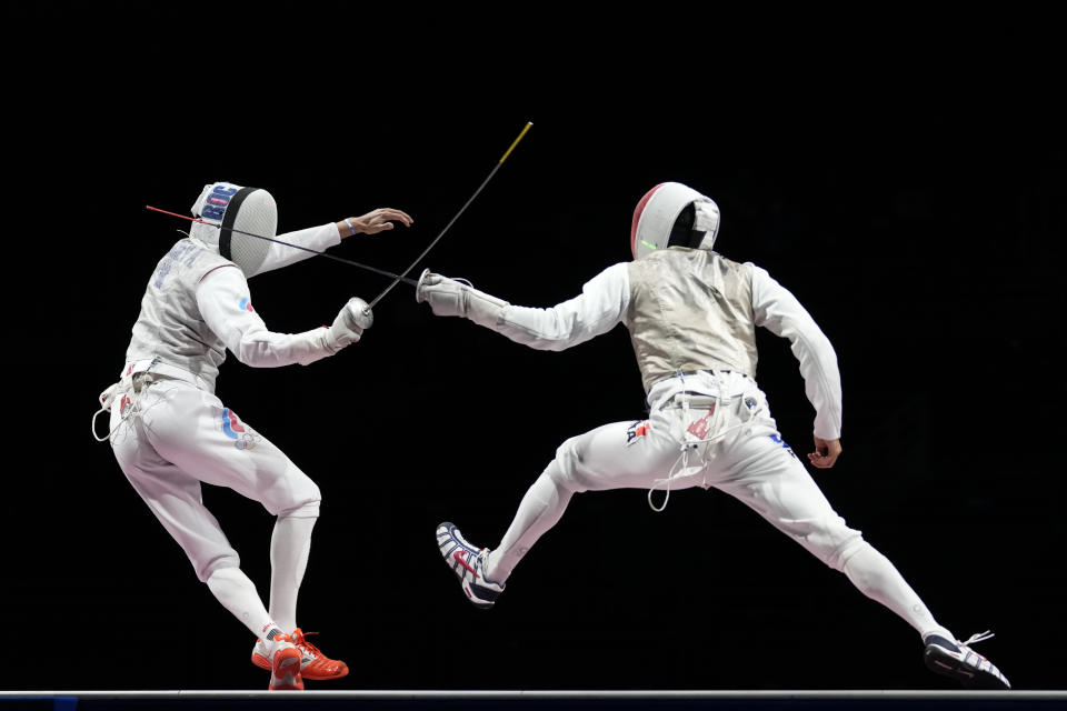 Anton Borodachev of the Russian Olympic Committee, left, and Erwann Le Pechoux of France compete in the men's Foil team final at the 2020 Summer Olympics, Sunday, Aug. 1, 2021, in Chiba, Japan. (AP Photo/Andrew Medichini)