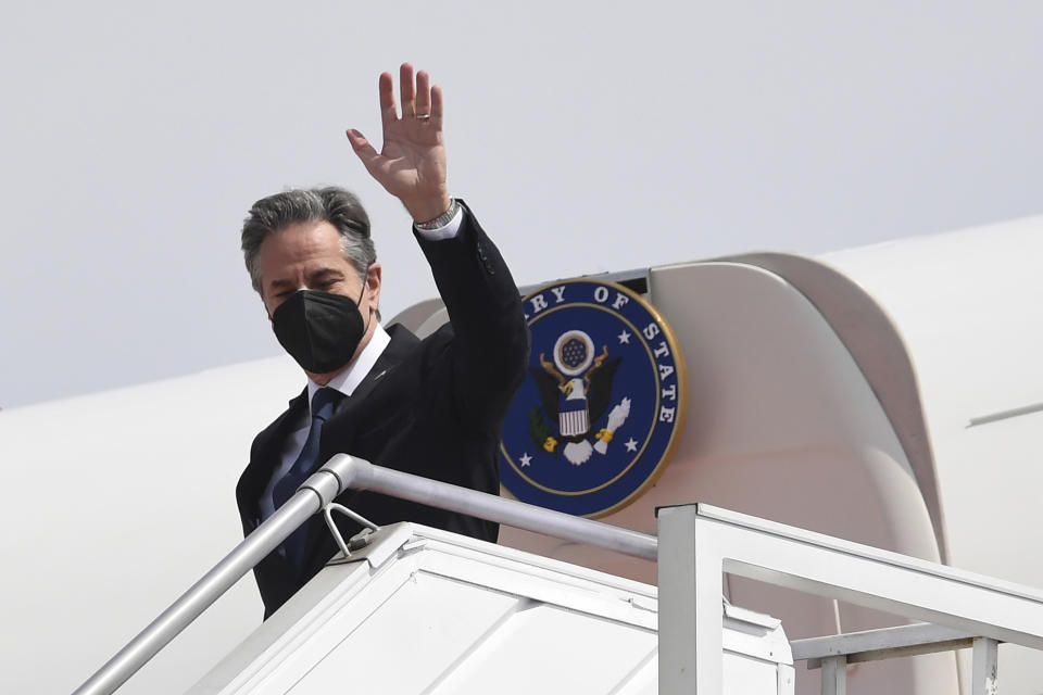U.S. Secretary of State Antony Blinken waves as he arrives at the international airport in Jakarta on Monday, Dec. 13, 2021. Blinken arrives in Indonesia on his first stop of a three-nation tour across Southeast Asia. (Olivier Douliery/Pool Photo via AP)