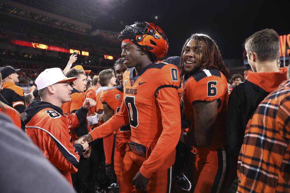 Oregon State quarterback Aidan Chiles (0) and running back Damien Martinez (6) celebrate the team’s 21-7 win over Utah with fans Friday, Sept. 29, 2023, in Corvallis, Ore. | Amanda Loman, Associated Press