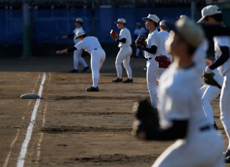 Members of Fukushima Commercial High School baseball team take part in a workout at the school's baseball field in Fukushima, Japan