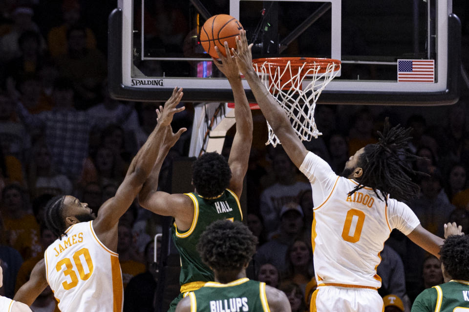 Tennessee forward Jonas Aidoo (0) and guard Josiah-Jordan James (30) try to block the shot of George Mason guard Keyshawn Hall (4) during the first half of an NCAA college basketball game Tuesday, Dec. 5, 2023, in Knoxville, Tenn. (AP Photo/Wade Payne)