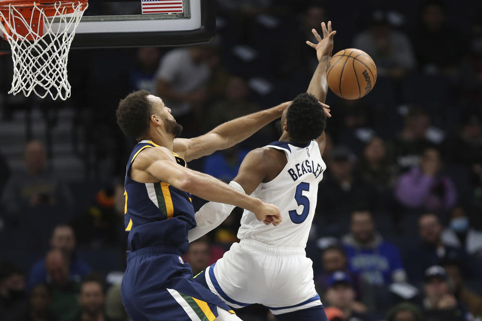 Utah Jazz center Rudy Gobert (27) knocks the ball out away from Minnesota Timberwolves guard Malik Beasley (5) during the first half of an NBA basketball game Wednesday Dec. 8, 2021, in Minneapolis. (AP Photo/Stacy Bengs)