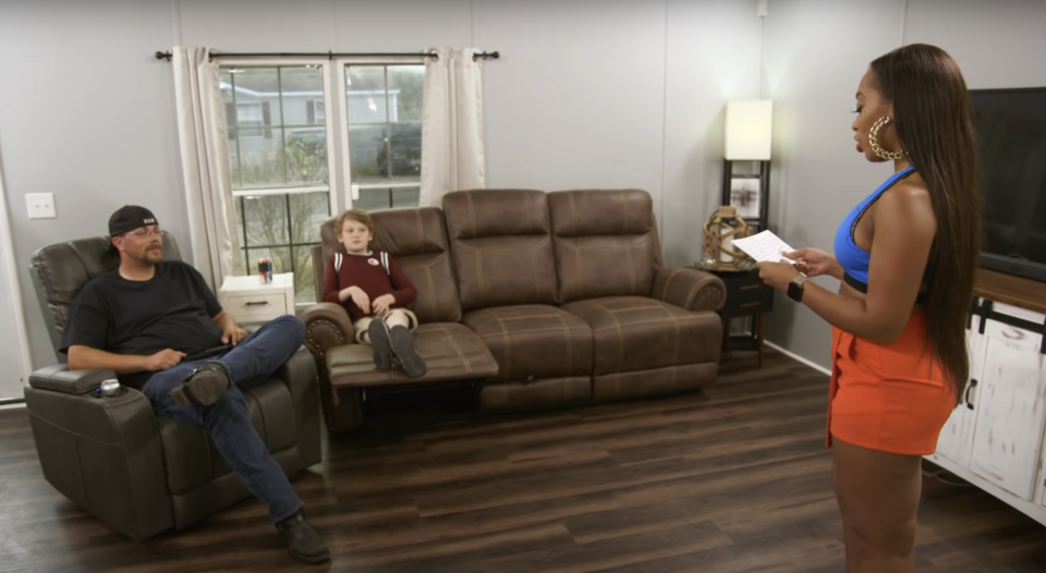 woman in a new house with a guy and his son sitting in the living room