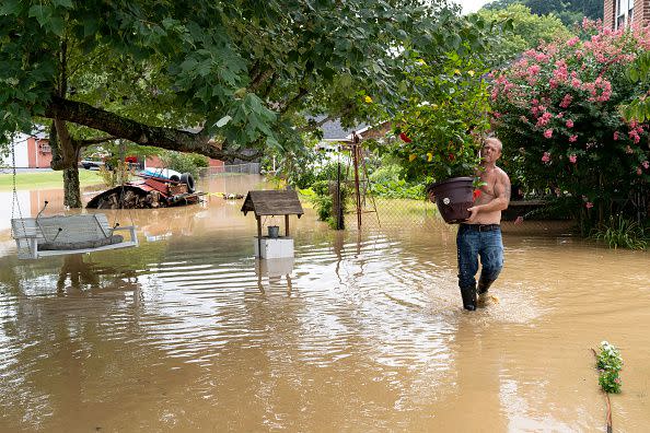 Cristopher Howard carries plants from his garden on July 28, 2022, in downtown Jackson, Kentucky.