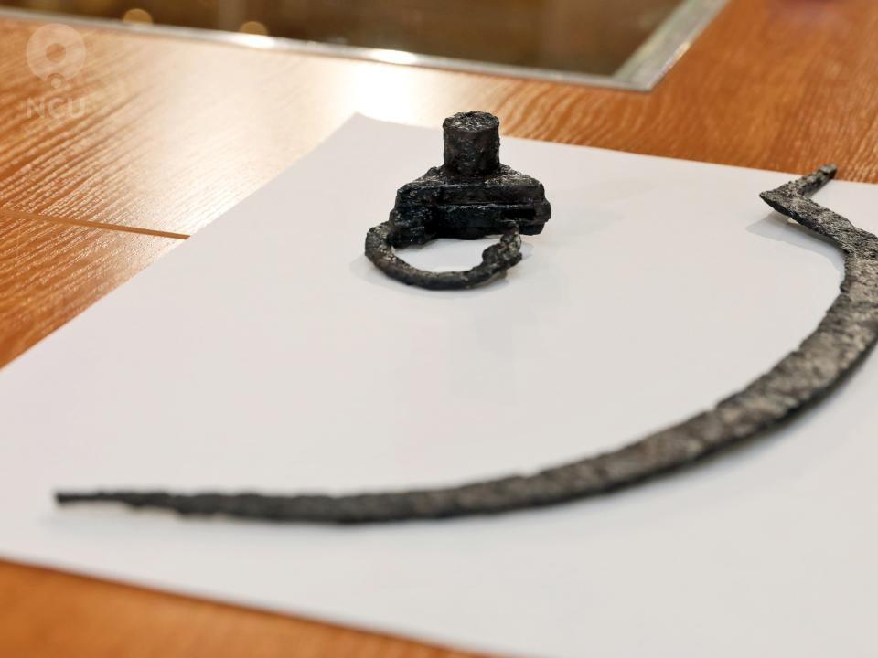 The blade and padlock found in Pién, Poland, shown here on a table.