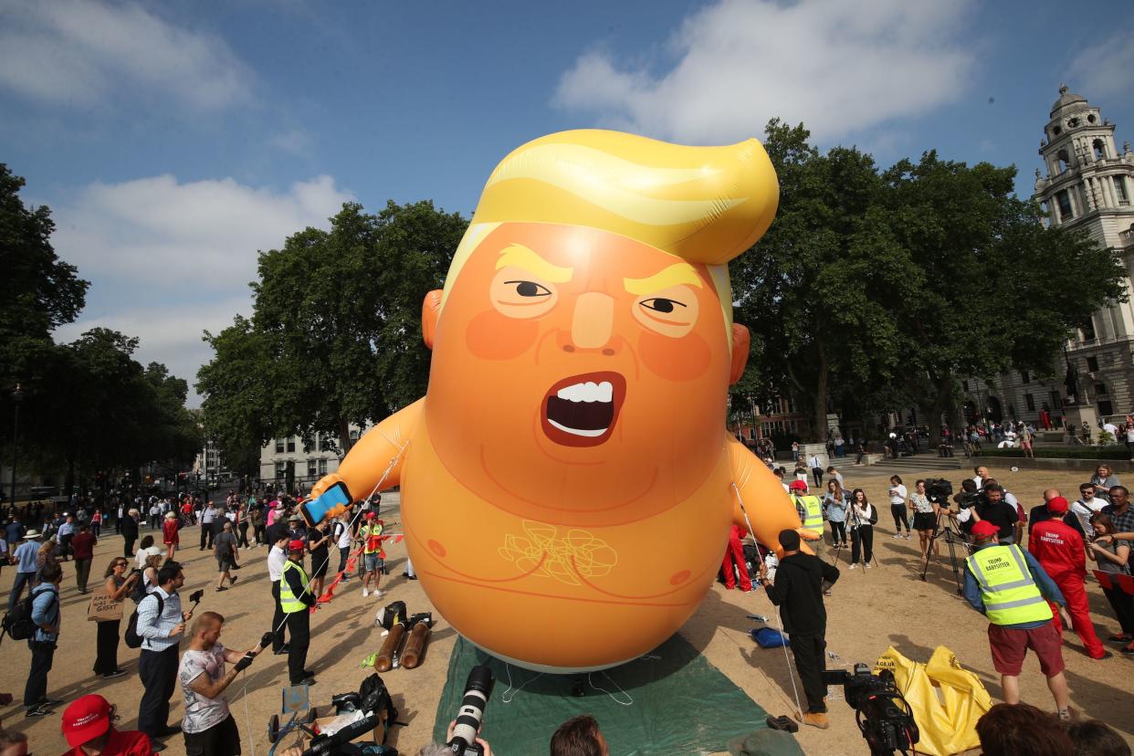 <p>‘Baby Trump’ balloon rising after being inflated in London’s Parliament Square, as part of the protests against Donald Trump’s visit to the UK. </p> (PA)