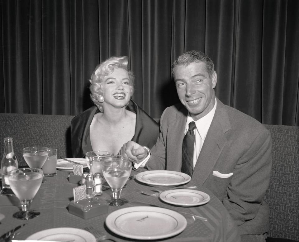 <p>By the time Monroe met New York Yankees baseball player Joe DiMaggio in 1952, she was one of Hollywood's biggest stars. According to <a href="https://www.biography.com/news/marilyn-monroe-joe-dimaggio-relationship" class="link " rel="nofollow noopener" target="_blank" data-ylk="slk:Biography">Biography</a>, DiMaggio requested a friend to arrange a date between him and Monroe, and the two connected right away. For the next two years, the couple dated and by 1954 DiMaggio was ready to take their relationship to the next level. Monroe recalled their decision to get married in her 1960 memoir "My Story," saying (via <a href="https://www.espn.com/mlb/s/dimaggiobook6th.html" class="link " rel="nofollow noopener" target="_blank" data-ylk="slk:ESPN">ESPN</a>), "Joe and I had been talking about getting married for some months… We knew it wouldn't be an easy marriage. On the other hand, we couldn't keep on going forever as a pair of cross-country lovers. It might begin to hurt both our careers." The pair married on Jan. 14, 1954, and honeymooned in Japan while DiMaggio handled business affairs. </p> <p>Monroe's sex symbol image was a point of contention for the couple. While DiMaggio wanted a stay-at-home wife to start a family with, Monroe did not want to be exclusively confined to that role and instead wanted to grow her career and perhaps a family at the same time. By October 1954, the pair's whirlwind marriage had disintegrated, and they filed for divorce. The icon's famous scene in "<a href="https://youtu.be/fIh6HDeXKGY?t=36" class="link " rel="nofollow noopener" target="_blank" data-ylk="slk:The Seven Year Itch">The Seven Year Itch</a>," in which her flowy white dress is blown up above her knees, was allegedly their breaking point, with Monroe saying (via <a href="https://people.com/movies/marilyn-monroes-most-famous-lovers-truth-vs-rumor/?slide=5884626#5884626" class="link " rel="nofollow noopener" target="_blank" data-ylk="slk:People">People</a>), "[DiMaggio] said ... exposing my legs and thighs, even my crotch - that was the last straw."</p> <p>Despite their marriage ending on rocky terms, DiMaggio and Monroe remained friends until her death in 1962. Devastated by the loss, the baseball player not only handled her funeral arrangements, but he also sent roses to her grave three times a week for over two decades, according to <a href="http://web.archive.org/web/20131005090536/https://www.nytimes.com/1999/03/09/sports/joe-dimaggio-yankee-clipper-dies-at-84.html?pagewanted=6&amp;src=pm" class="link " rel="nofollow noopener" target="_blank" data-ylk="slk:The New York Times">The New York Times</a>. </p>