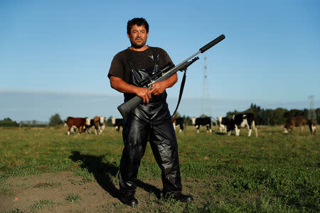 Noel Womersley, from Canterbury Homekill butchery, poses with his Sako 85 hunting rifle at his farm outside Christchurch, New Zealand March 28, 2019. REUTERS/Jorge Silva