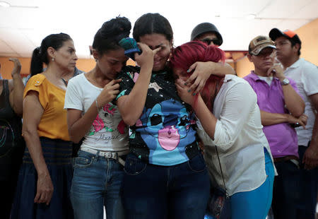 Family members and friends mourn the victims of a fire that broke out in a building in Managua, Nicaragua June 16, 2018. REUTERS/Oswaldo Rivas