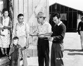 <p>This is a New Japanese family checking in at the big assembly center in Santa Anita, California July 2, 1942, that was established at the race track after the start of the war for West Coast people of Japanese descent. Some 18,500 men, women and children, two thirds of them American citizens, are housed in barracks at the center. They have their own schools under the grandstand in the long room lined with windows, where formerly bets were placed by race track visitors. The internees are fed well and though they live under military rules, their mail censored, and barbed wire surrounding them, various forms of recreation help to make their life more life more. Teams have been formed at the center, diamond fans are rabid. (AP Photo) </p>