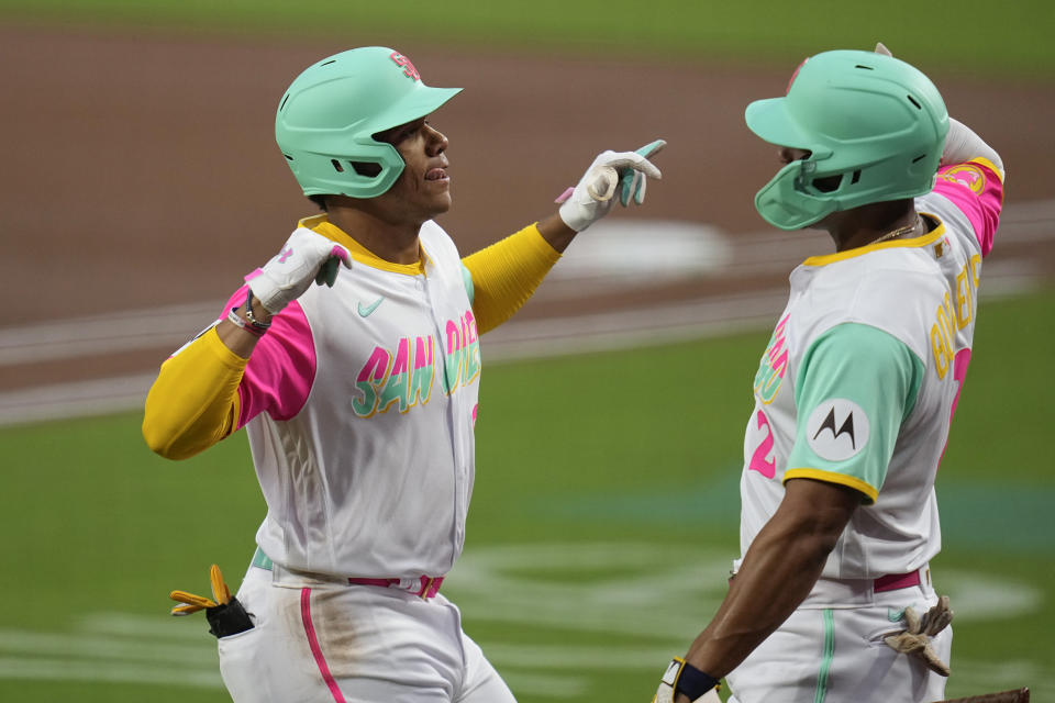 San Diego Padres' Juan Soto, left, celebrates with teammate Xander Bogaerts after hitting a home run during the first inning of a baseball game against the San Francisco Giants, Friday, Sept. 1, 2023, in San Diego. (AP Photo/Gregory Bull)