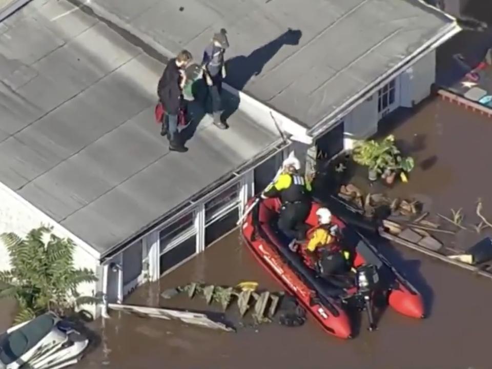 Two people are rescued off a roof in a town north of Philadelphia.