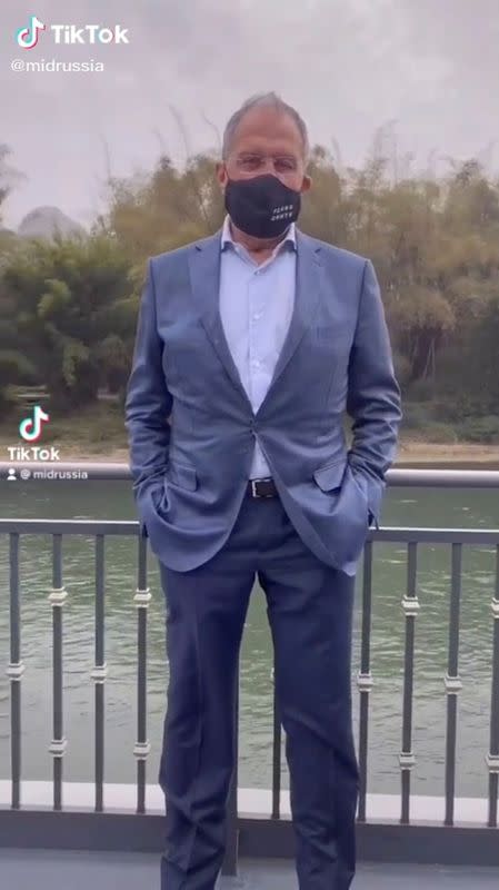 Russia's Foreign Minister Sergei Lavrov wearing a protective face mask poses for a picture in Guilin