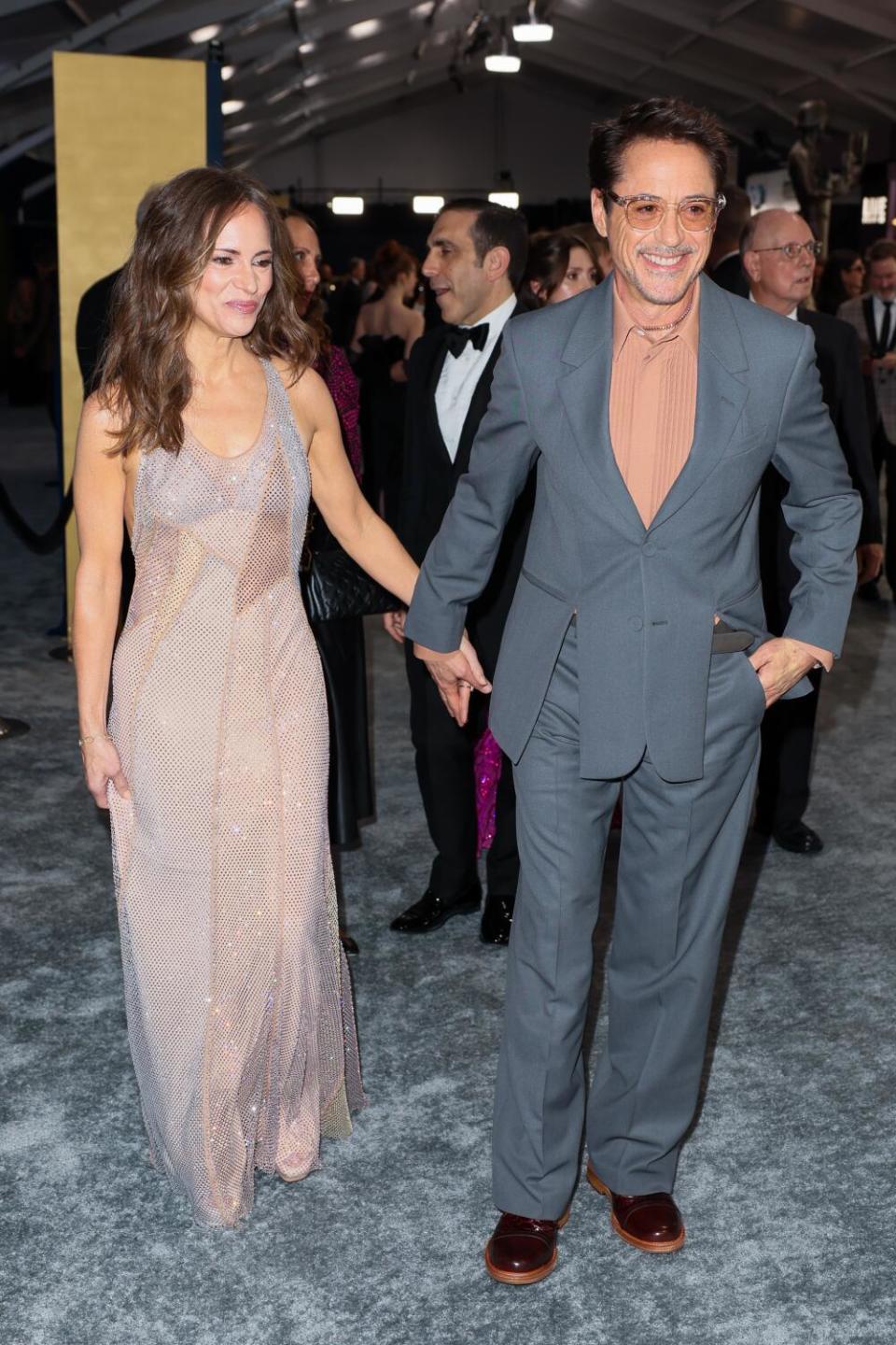 Robert Downey Jr. and Susan Downey, in a grey suit, at the SAG Awards.