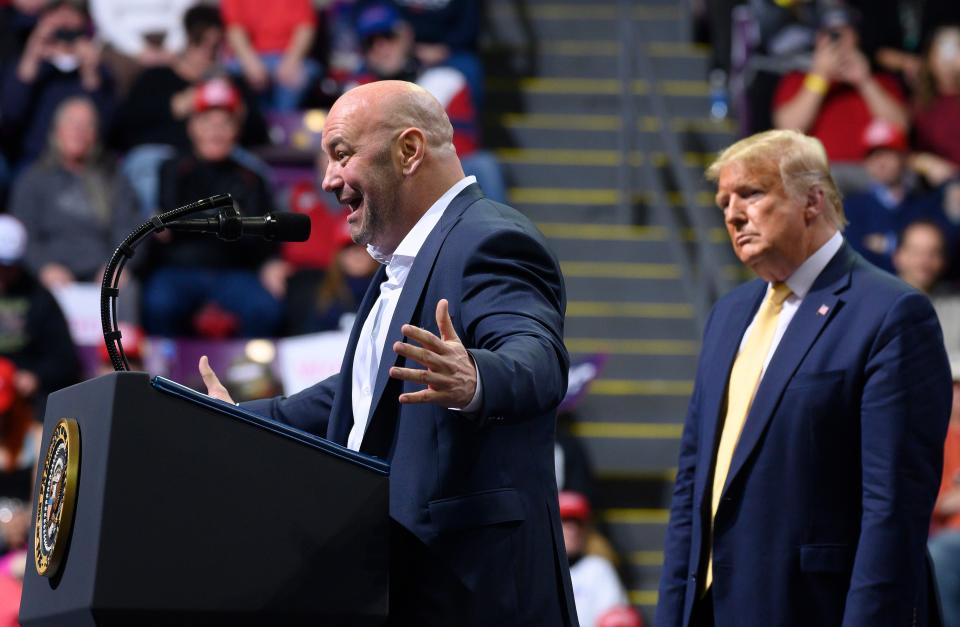 US President Donald Trump looks on as UFC president Dana White talks at a 2020 rally