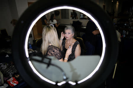 Holocaust survivor Riva Levin, 81, gets make up before the beginning of the annual Holocaust survivors' beauty pageant in Haifa, Israel October 14, 2018. REUTERS/Corinna Kern