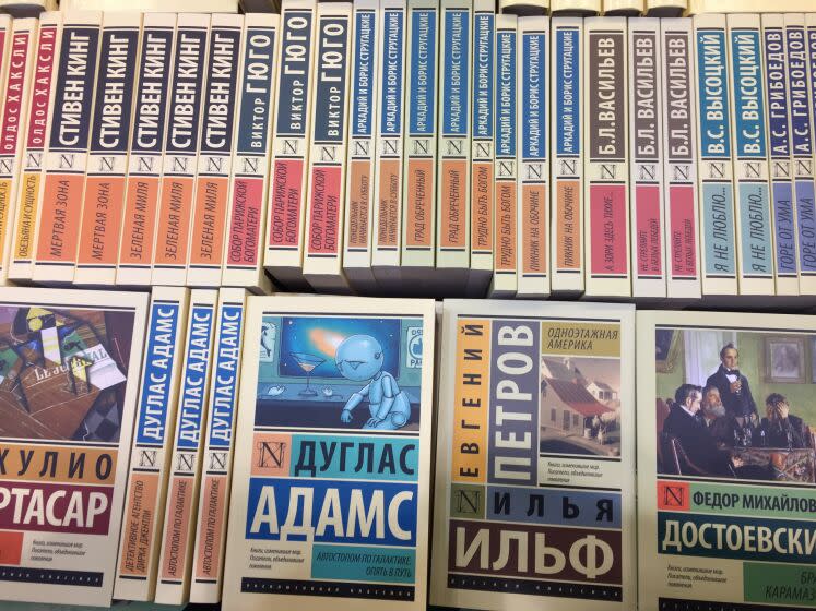 Russian and international classics are standing in a bookshelf of a stand at the international book fair in Moscow, Russia, 06 September 2017. Blue in the middle: Douglas Adams, The Hitchhiker's Guide to the Galaxy; to the right Ilja Ilf/Yevgeni Petrov, One-storied America and Fyodor Dostoyevsky, The Brothers Karamazov. Circa 600 publishers from 39 countries participate in the largest book fair in Russia and the former Soviet Union, which is on until 10 September 2017. Photo: Friedemann Kohler/dpa (Photo by Friedemann Kohler/picture alliance via Getty Images)